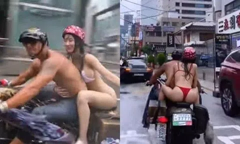 Cặp đôi ăn mặc hở tung như không mặc, lái xe máy tắm mưa, cư dân mạng tranh cãi dữ dội