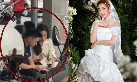 Đỗ Mỹ Linh và con trai bầu Hiển ngồi ăn lề đường, lộ thời điểm đám cưới trùng với 3 sao Việt