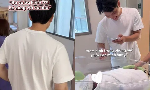 Chồng Á hậu Chế Nguyễn Quỳnh Châu cẩn thận xem hình trên điện thoại trước khi nhận con từ điều dưỡng bệnh viện